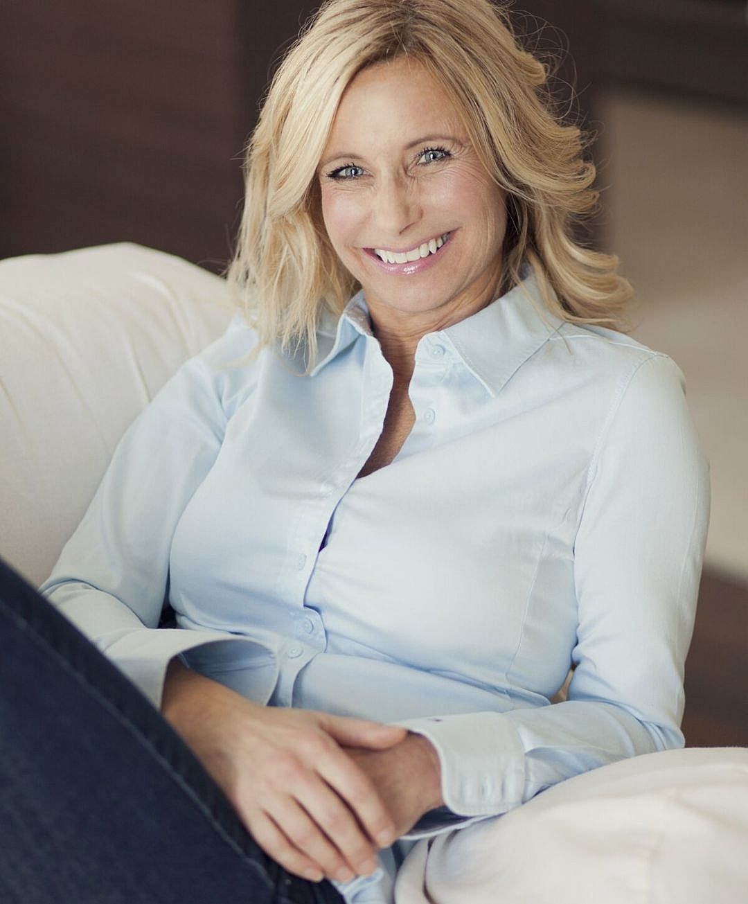 two women holding each other on couch