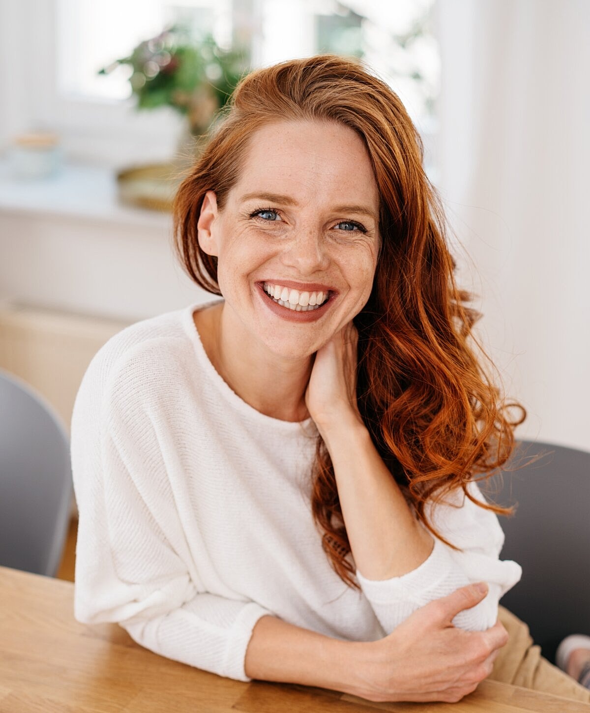 two women holding each other on couch